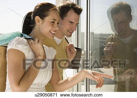 Couple window shopping View Large Photo Image Stock Image - Couple window shopping. Fotosearch