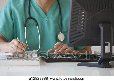Stock Photo - Doctor writing on chart. Fotosearch