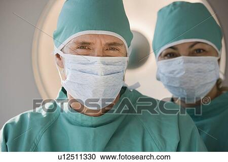 Doctors wearing surgical masks View Large Photo Image Stock Image - Doctors wearing surgical masks. Fotosearch