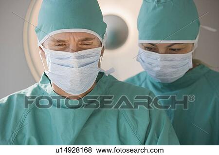 Doctors wearing surgical masks View Large Photo Image Stock Photo - Doctors wearing surgical masks. Fotosearch
