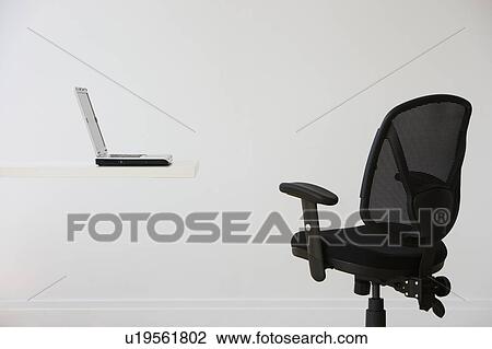 Stock Image - Empty desk with laptop. Fotosearch