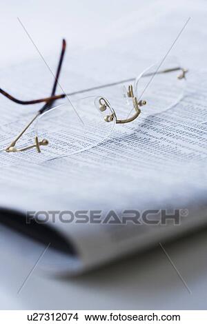 Eyeglasses on newspaper View Large Photo Image Picture - Eyeglasses on newspaper. Fotosearch