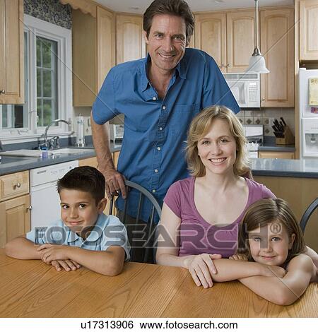 Family at kitchen table View Large Photo Image Stock Photograph - Family at kitchen table. Fotosearch