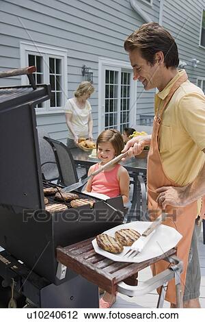 Family barbequing on deck View Large Photo Image Stock Image - Family barbequing on deck. Fotosearch