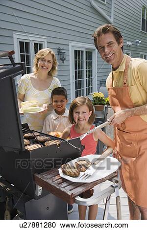 Family barbequing on deck View Large Photo Image Stock Image - Family barbequing on deck. Fotosearch