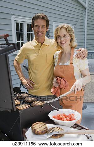 Family barbequing on deck View Large Photo Image Stock Photograph - Family barbequing on deck. Fotosearch