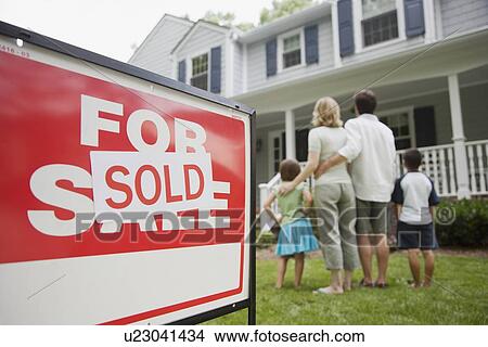 Picture - Family looking at new house. Fotosearch