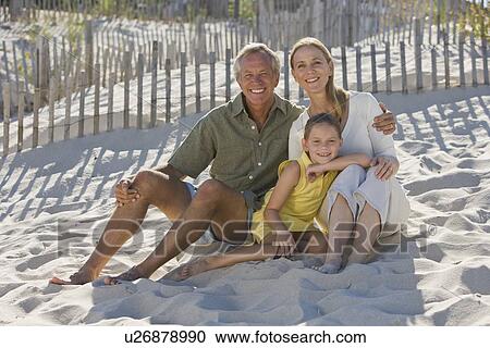 Family sitting on beach View Large Photo Image Stock Image - Family sitting on beach. Fotosearch
