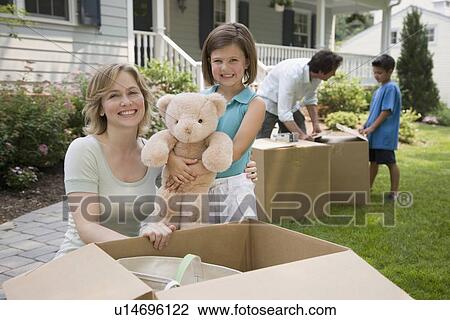 Family unpacking moving boxes View Large Photo Image Stock Image - Family unpacking moving boxes. Fotosearch