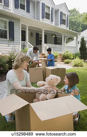 Family unpacking moving boxes View Large Photo Image Stock Photo - Family unpacking moving boxes. Fotosearch