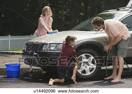 Stock Photograph - Family washing car in driveway. Fotosearch