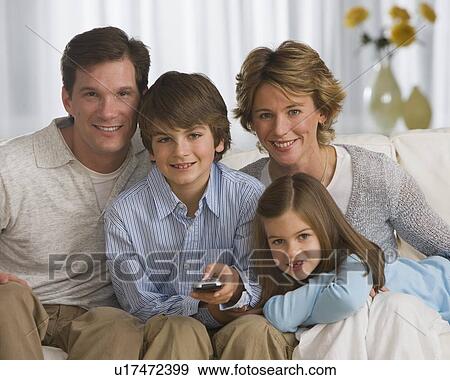 Family watching television View Large Photo Image Stock Photo - Family watching television. Fotosearch