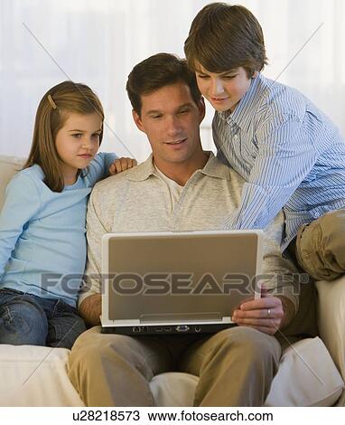 Father and children looking at laptop View Large Photo Image Stock Image - Father and children looking at laptop. Fotosearch