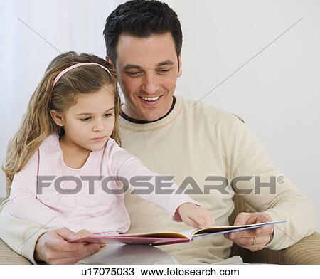 Stock Image - Father and daughter reading. Fotosearch