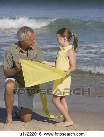 Father and daughter with kite at beach View Large Photo Image Stock Photograph - Father and daughter with kite at beach. Fotosearch