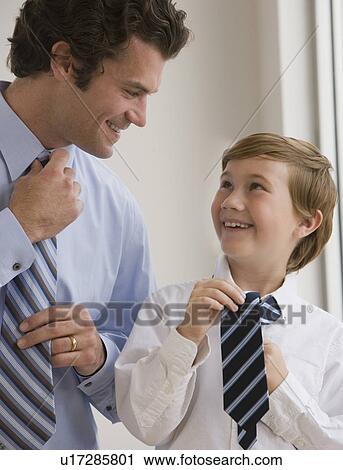Father and son tying neckties View Large Photo Image Stock Image - Father and son tying neckties. Fotosearch