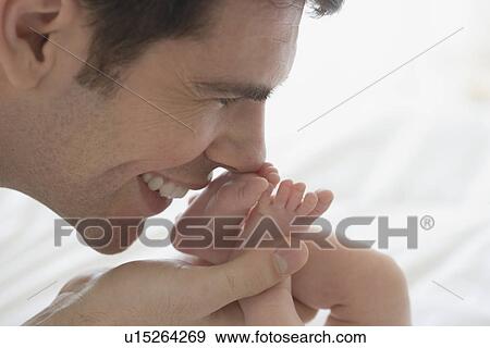 Father kissing newborn baby's feet View Large Photo Image Stock Photo - Father kissing newborn baby's feet. Fotosearch