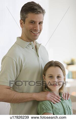 Stock Photo - Father with hands on daughter’s shoulders. Fotosearch