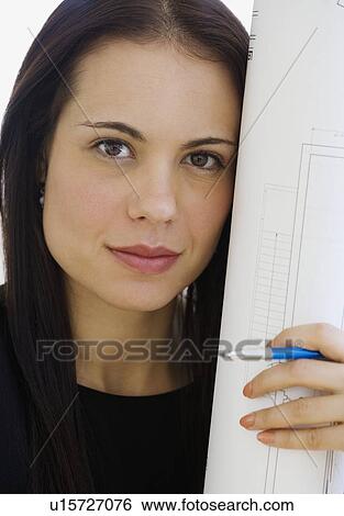 Female architect holding blueprints View Large Photo Image Stock Photograph - Female architect holding blueprints. Fotosearch