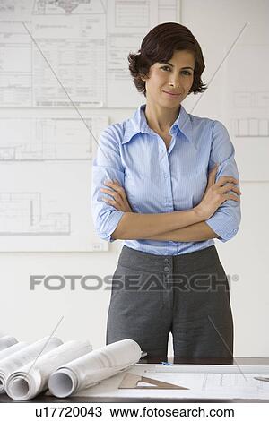Stock Image - Female architect with arms crossed. Fotosearch