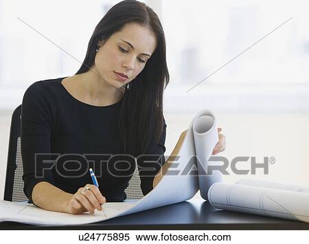 Female architect writing on blueprints View Large Photo Image Stock Photography - Female architect writing on blueprints. Fotosearch
