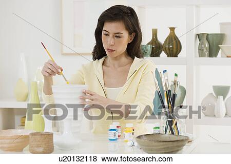 Female artist painting pottery View Large Photo Image Stock Photo - Female artist painting pottery. Fotosearch