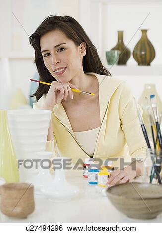 Female artist painting pottery View Large Photo Image Stock Photograph - Female artist painting pottery. Fotosearch
