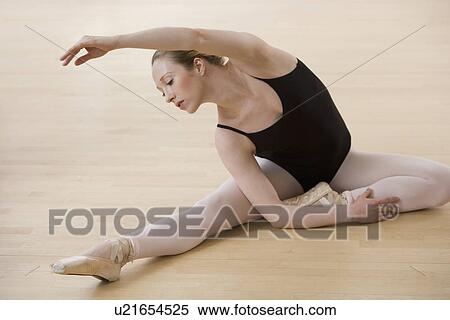 Female ballet dancer stretching on floor View Large Photo Image Stock Photography - Female ballet dancer stretching on floor. Fotosearch