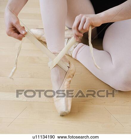 Female ballet dancer tying pointe shoes View Large Photo Image Stock Image - Female ballet dancer tying pointe shoes. Fotosearch