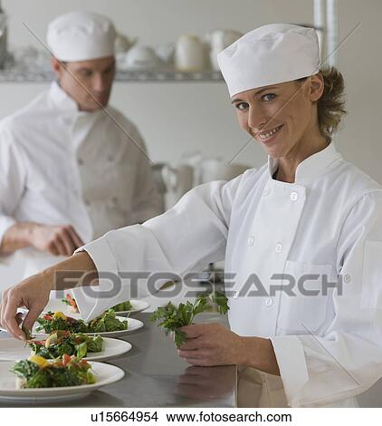 Female chef plating food View Large Photo Image Picture - Female chef plating food. Fotosearch