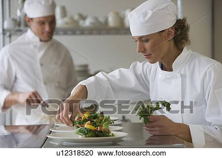 Female chef plating food View Large Photo Image Stock Image - Female chef plating food. Fotosearch