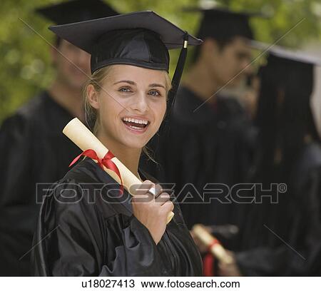 Stock Image - Female college graduate holding diploma. Fotosearch