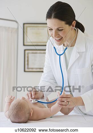 Female doctor examining baby View Large Photo Image Stock Image - Female doctor examining baby. Fotosearch