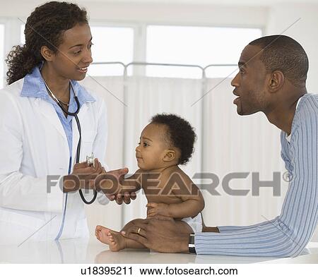 Stock Image - Female doctor examining baby. Fotosearch