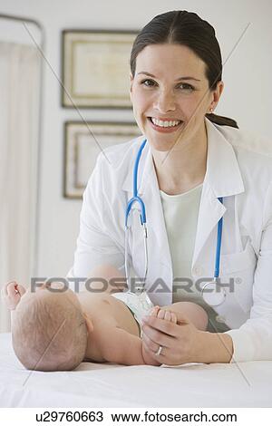 Female doctor examining baby View Large Photo Image Stock Image - Female doctor examining baby. Fotosearch