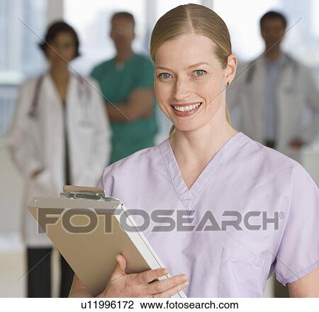 Stock Image - Female doctor holding chart. Fotosearch