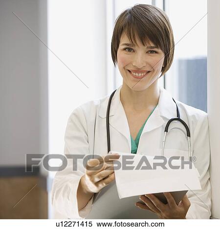 Female doctor holding chart View Large Photo Image Stock Photography - Female doctor holding chart. Fotosearch