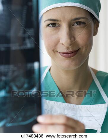 Female doctor holding x-ray View Large Photo Image Stock Photograph - Female doctor holding x-ray. Fotosearch