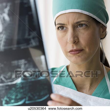 Picture - Female doctor looking at x-ray. Fotosearch