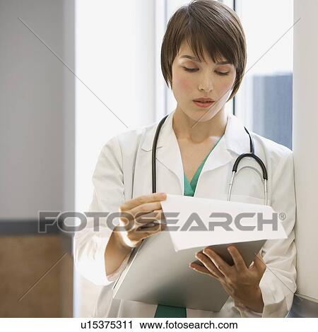 Female doctor reading chart View Large Photo Image Stock Image - Female doctor reading chart. Fotosearch