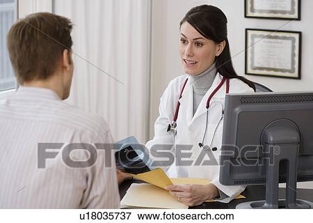 Female doctor talking to patient in office View Large Photo Image Stock Photo - Female doctor talking to patient in office. Fotosearch