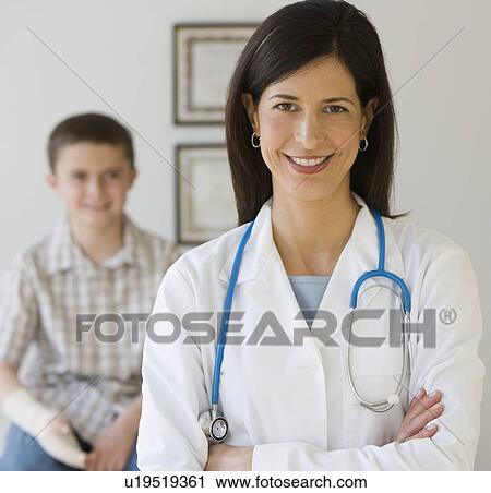 Female doctor with boy in background View Large Photo Image Stock Image - Female doctor with boy in background. Fotosearch