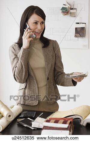 Female interior designer talking on cell phone View Large Photo Image Stock Photography - Female interior designer talking on cell phone. Fotosearch