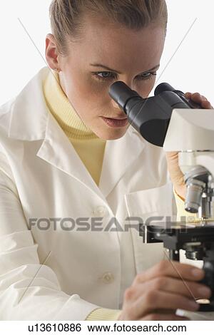 Female scientist looking in microscope View Large Photo Image Stock Photograph - Female scientist looking in microscope. Fotosearch
