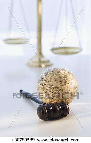 Stock Photo - Gavel and globe with scales in background. Fotosearch