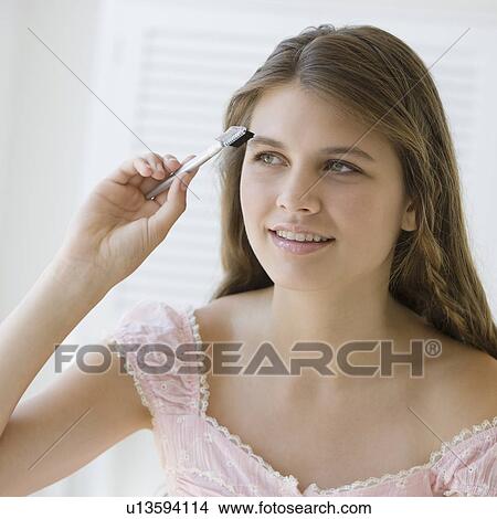 Girl brushing eyebrows View Large Photo Image Picture - Girl brushing eyebrows. Fotosearch