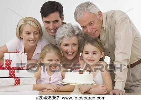 Girl celebrating birthday with family View Large Photo Image Stock Photo - Girl celebrating birthday with family. Fotosearch