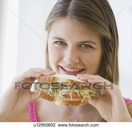Girl eating sandwich View Large Photo Image Stock Image - Girl eating sandwich. Fotosearch