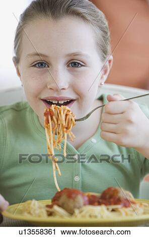 Girl eating spaghetti and meatballs View Large Photo Image Stock Image - Girl eating spaghetti and meatballs. Fotosearch