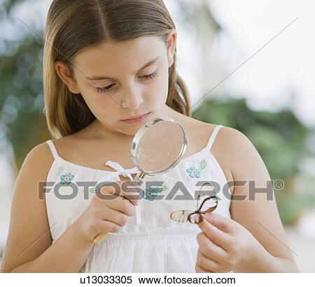 Stock Photography - Girl examining butterfly. Fotosearch